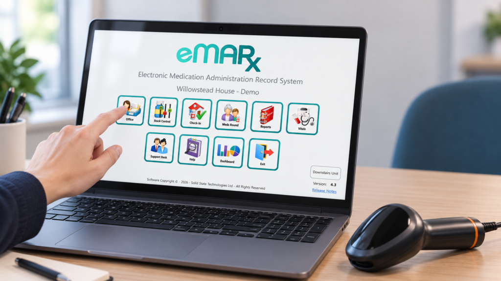 eMARx medication administration system displayed on a laptop beside a barcode scanner.